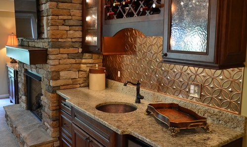 Giallo Napoli Granite Countertop with Chocolate Ebony Glazed Cherry Cabinets, Copper Panel Backsplash and Natural Slate Tile Wall